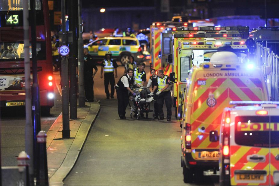 Police and emergency responders attend to an injured person.