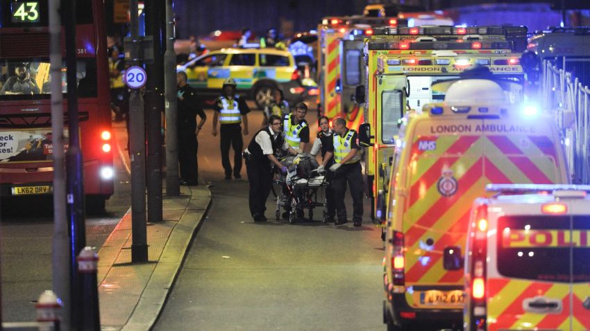 Police officers and members of the emergency services attend to a person injured in an apparent terror attack on London Bridge in central London on June 3, 2017.
Armed police fired shots after reports of stabbings and a van hitting pedestrians on London Bridge on Saturday in an incident reminiscent of a terror attack in March just days ahead of a general election. / AFP PHOTO / DANIEL SORABJI        (Photo credit should read DANIEL SORABJI/AFP/Getty Images)