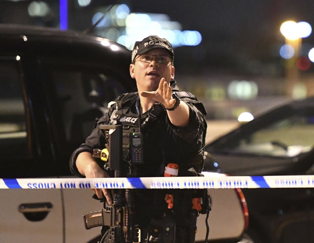 An armed Police officer gestures after the attack in central London.