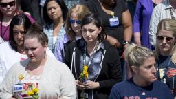 A group gathers to observe a minute of silence at an impromptu memorial at the Hollywood Transit Center on June 2, 2017 in Portland, Oregon. The center was the site where last week three men were stabbed, two fatally, after they stood up for two women who were being harassed on a MAX train.