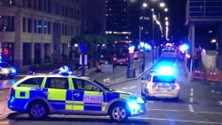 TOPSHOT - A photograph taken on a mobile phone shows British police cars blocking the entrance to London Bridge, in central London on June 3, 2017, following an incident on the bridge. 
Police are dealing with a "major incident" on London Bridge, Transport for London said on Saturday, after witnesses reported seeing a van mounting the pavement and hitting pedestrians. / AFP PHOTO / Daniel SORABJI        (Photo credit should read DANIEL SORABJI/AFP/Getty Images)