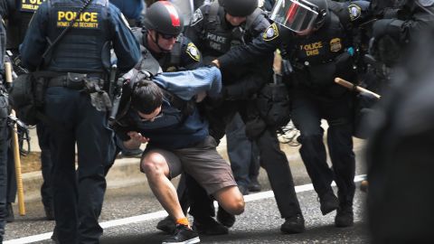 Police arrest a demonstrator during competing rallies in Portland, Oregon on Sunday. 