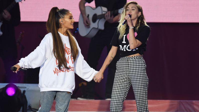 Ariana Grande and Miley Cyrus sing a duet.