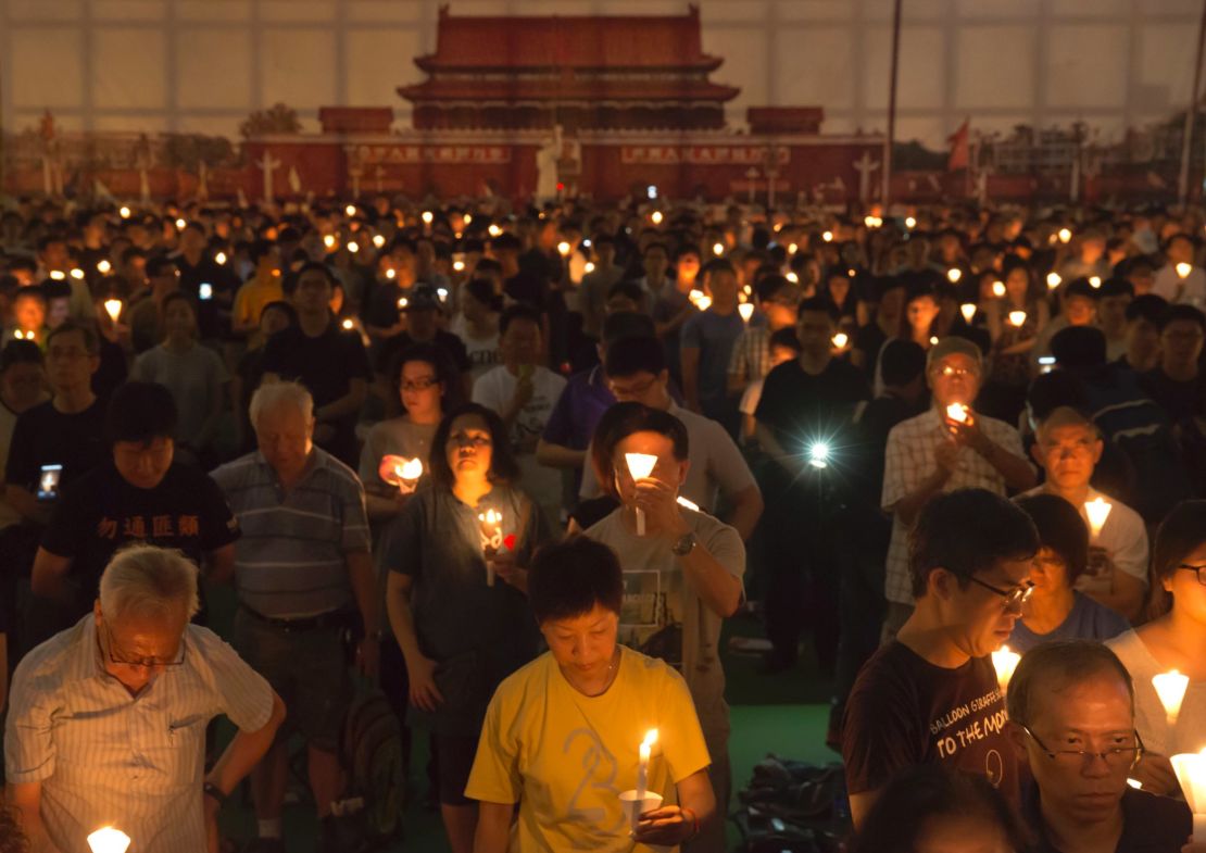 Tens of thousands of people attend an annual candlelight vigil at Hong Kong's Victoria Park, Sunday, June 4, 2017. 