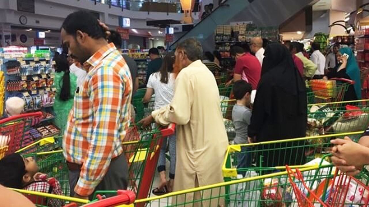 People are seen buying essential food staples at a supermarket in Doha, Qatar, Monday, June 5, 2017.