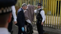 Police officers escort a person, with their head covered, to a police van, in Barking, east London on June 5, 2017, following a dawn raid on a property (R), as thier investigations continue following the June 3 terror attacks in central London.Police carried out fresh raids and arrested "a number of people" on Monday after the Islamic State group claimed an attack by three men who mowed down and stabbed revellers in London on June 3, killing seven people, before being shot dead by officers. / AFP PHOTO / Daniel LEAL-OLIVAS        (Photo credit should read DANIEL LEAL-OLIVAS/AFP/Getty Images)