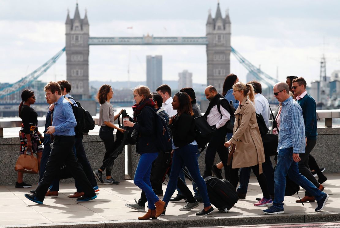 Commuters walk across London Bridge on Monday after it partially reopened.