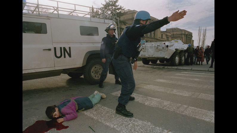 United Nations firefighters at the scene where Nermin Divovic, 7, was shot and killed by a sniper in Sarajevo's infamous "Sniper Alley" on November 18, 1994. <a href="index.php?page=&url=http%3A%2F%2Fwww.cnn.com%2F2015%2F06%2F05%2Feurope%2Fsarajevo-then-and-now%2Findex.html">Sarajevo endured years of fighting during the Bosnian conflict</a>, which left more than 11,000 people dead in Sarajevo and an estimated 100,000 to 150,000 dead across the country.