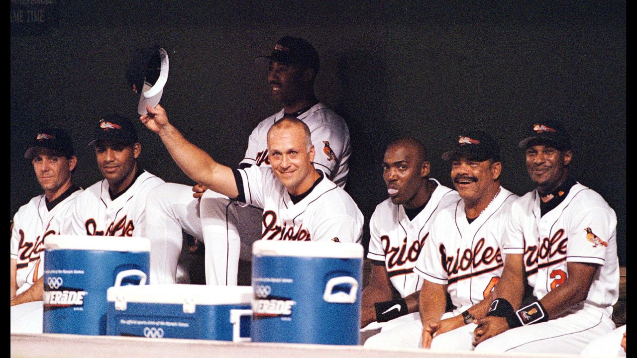 Revered as baseball's "Iron Man," Cal Ripken Jr. tips his hat to the fans at Baltimore's Camden Yards after sitting out the Orioles game on September 20, 1998. Ripken's decision not to play brought an end to his streak of 2,632 consecutive games played. The record was previously held by Lou Gehrig, who Ripken surpassed by 501 games. 