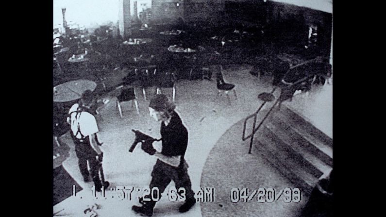 Surveillance tape from Columbine High School on April 20, 1999, shows Eric Harris, left, and Dylan Klebold carrying guns through the school's cafeteria. The two students carried out <a href="index.php?page=&url=http%3A%2F%2Fwww.cnn.com%2F2013%2F09%2F18%2Fus%2Fcolumbine-high-school-shootings-fast-facts%2Findex.html">one of the deadliest school shootings in US history</a>, killing 12 students and one teacher, before turning the guns on themselves in the school's library.