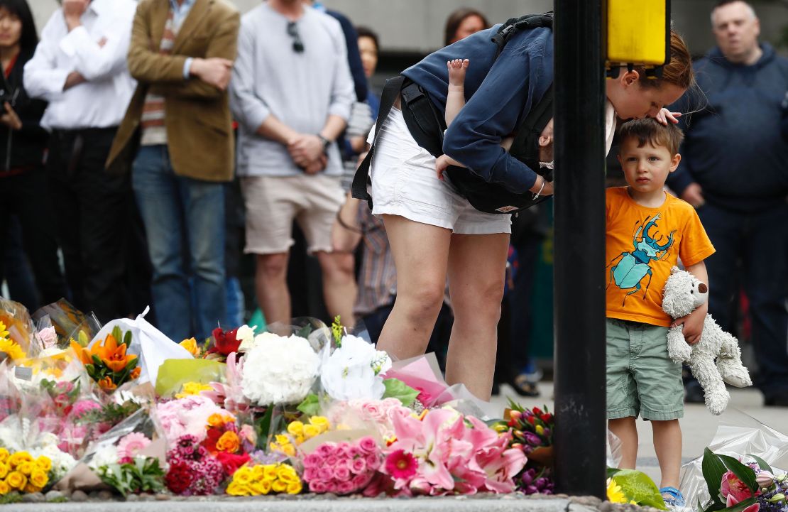 A woman and child lay flowers near London Bridge on Monday to remember the victims of the attack.