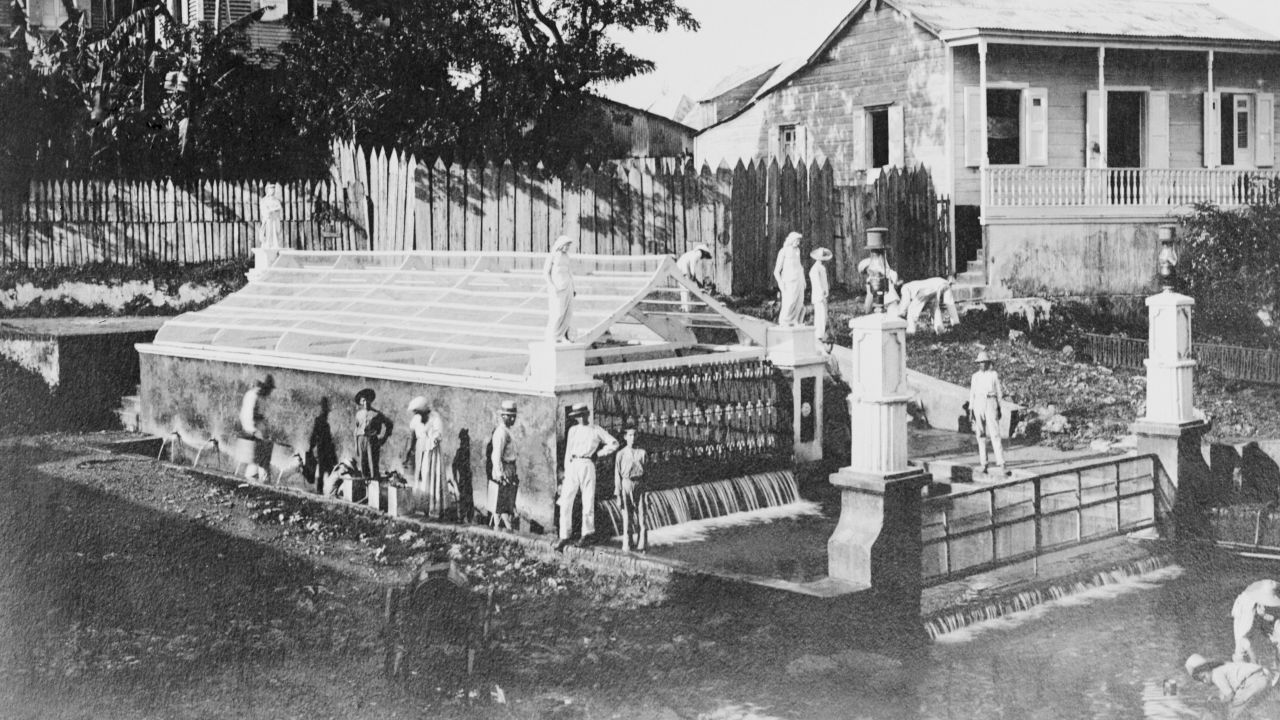 People fill pails with water at the Christopher Columbus Fountain in Aguadilla, Puerto Rico, in 1920. Here, Columbus is said to have stepped on the shore and taken his first American drink.
