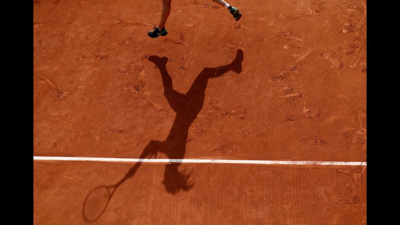 Eugenie Bouchard's shadow is seen on the Roland Garros clay as she plays her first-round match at the French Open on Tuesday, May 30.