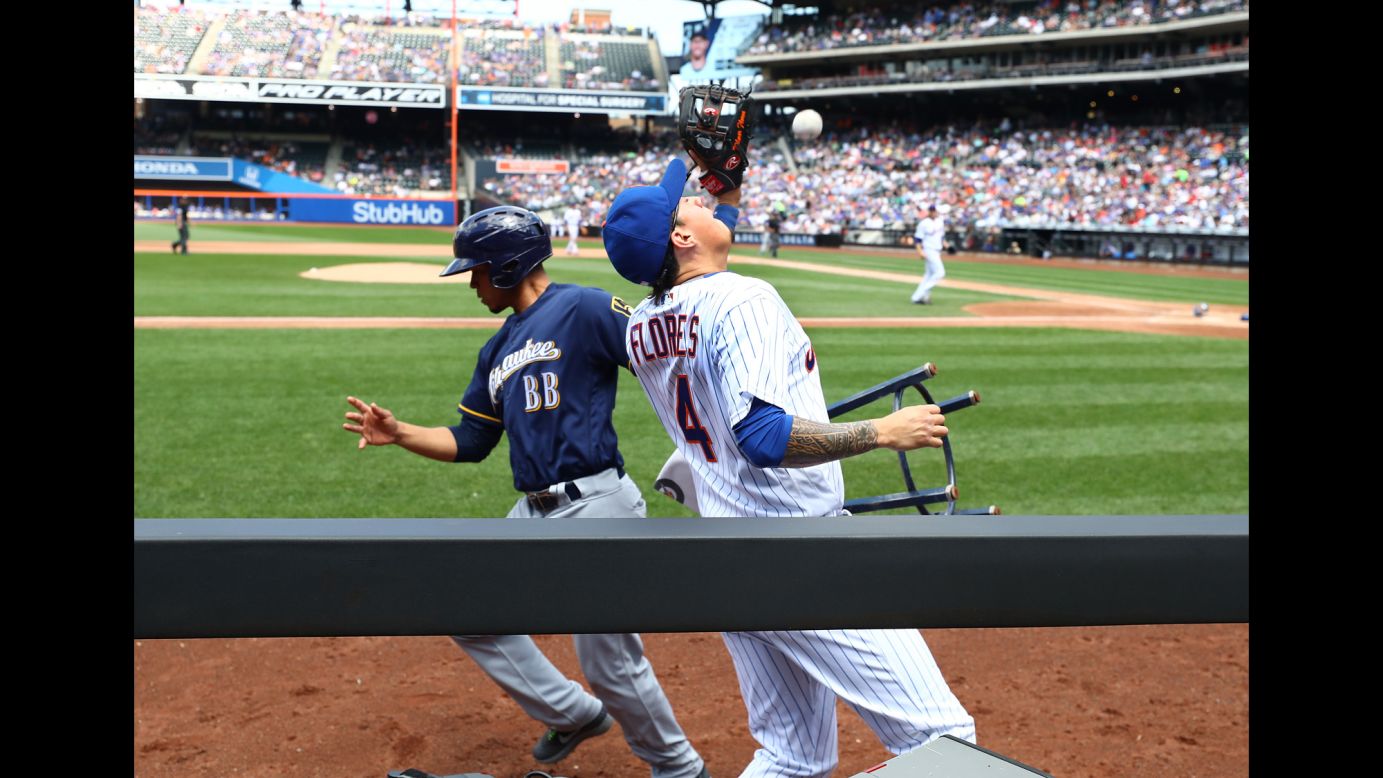 A batboy runs away from Wilmer Flores as the New York Mets infielder tries to catch a foul ball on Thursday, June 1. Flores was unable to make the catch. The ruling on the field was that there was no interference.