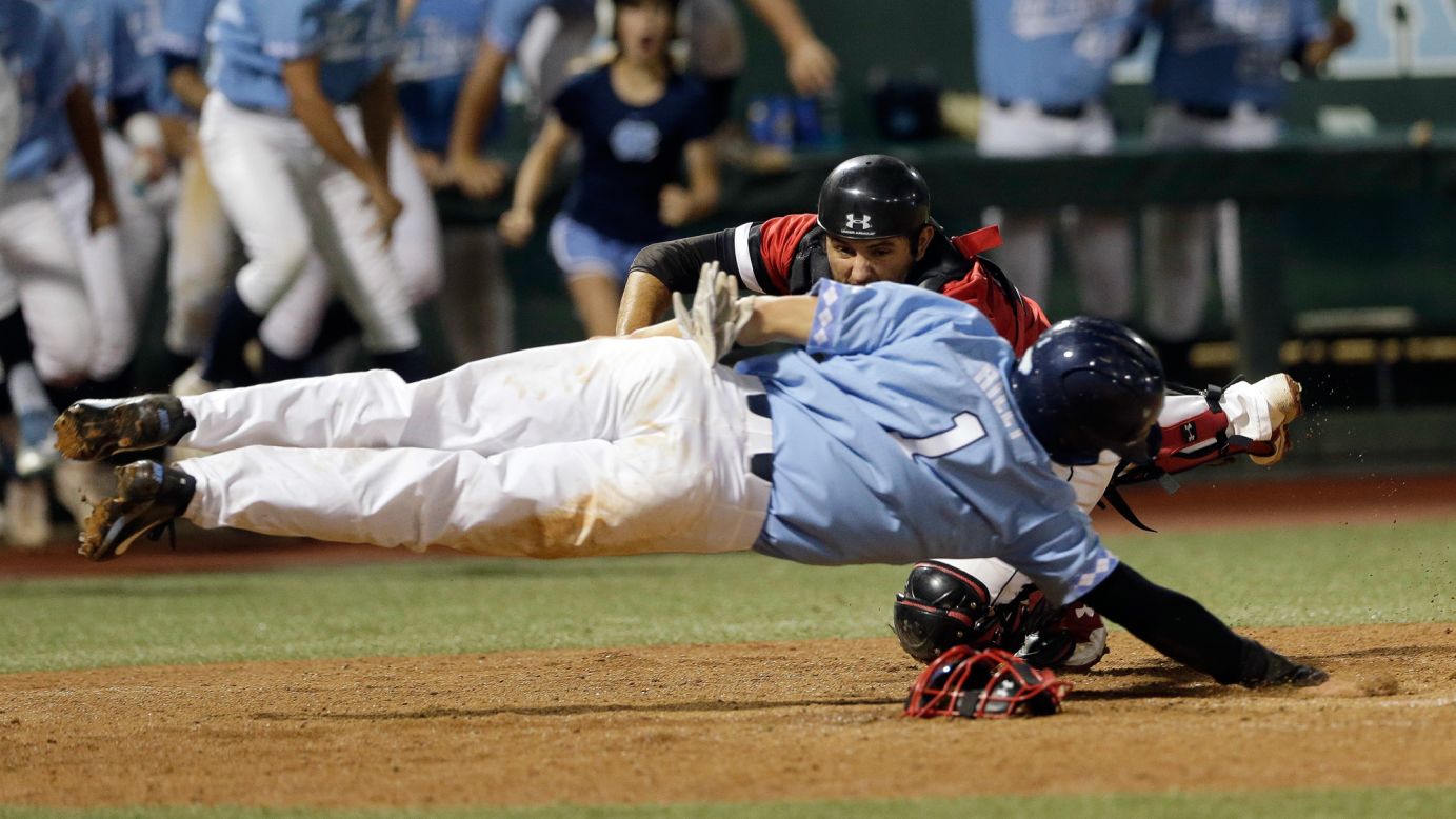 Davidson catcher Jake Sidwell tags out North Carolina's Brandon Riley during a college baseball game in Chapel Hill, North Carolina, on Sunday, June 4. Davidson won 2-1 to advance to the NCAA Super Regionals.