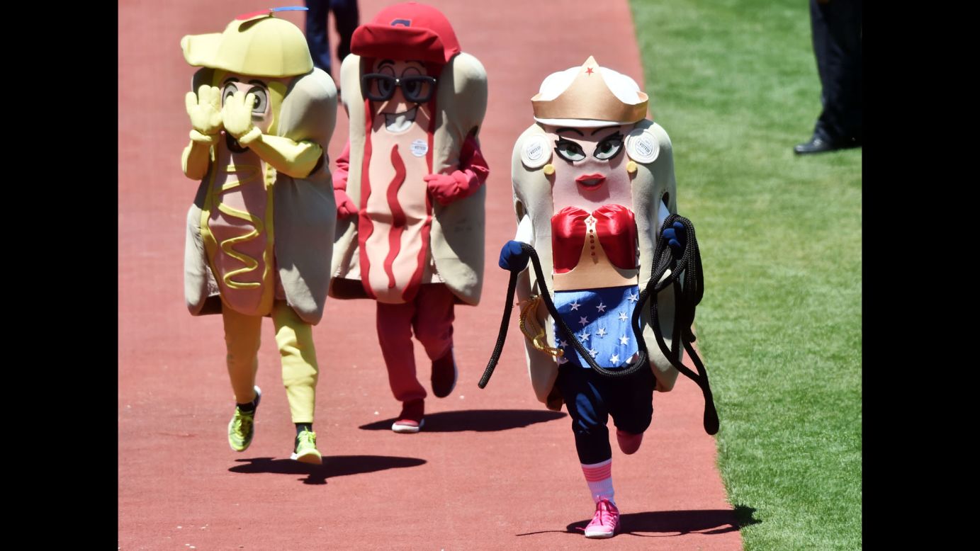 The onion hot dog, dressed as Wonder Woman, takes the lead during the Hot Dog Derby mascot race in Cleveland on Thursday, June 1.