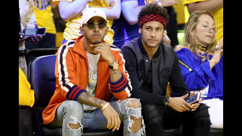 Formula One driver Lewis Hamilton, left, and Brazilian soccer star Neymar attend Game 2 of the NBA Finals on Sunday, June 4.