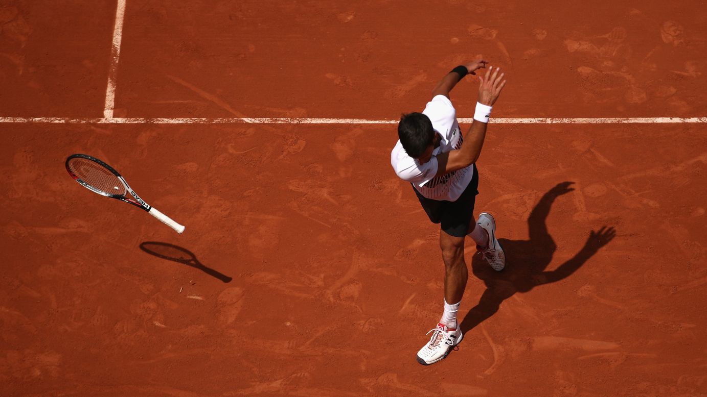 Novak Djokovic throws his racket in frustration during a second-round match at the French Open on Wednesday, May 31. He still won the match in straight sets.