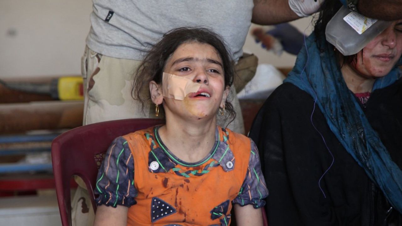 Ten-year-old Mariam Salim cries as she is treated at a makeshift clinic in western Mosul. She was trying to make a run for it with her family on June 4, 2017, when their house collapsed from an explosion. Most in her family are buried under the rubble of what was their home.