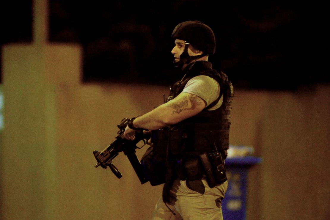 An armed police officer walks at the scene of the attack on June 5, in the Melbourne suburb of Brighton.