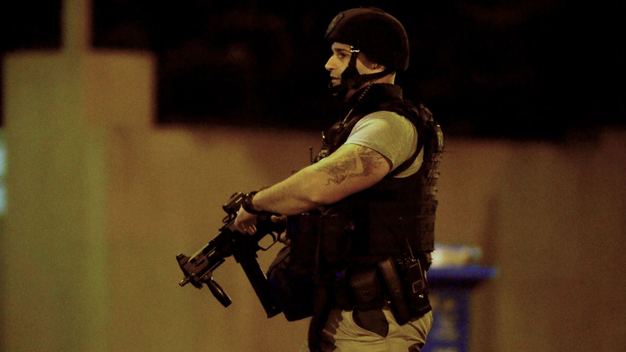An armed police officer walks at the scene of the attack on June 5, in the Melbourne suburb of Brighton.