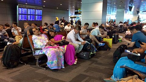 Passengers of cancelled flights wait on Tuesday, June 6, in Hamad International Airport in Doha, Qatar.