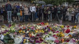 LONDON, ENGLAND - JUNE 05:  Members of the public gather near flowers on the South side of London Bridge, close to Borough Market in London in tribute to the victims of the June 3 attacks, on June 5, 2017 in London, England. British police on Monday made several arrests in two dawn raids following the June 3 London attacks, claimed by the Islamic State group which left seven people dead.  (Photo by Dan Kitwood/Getty Images)