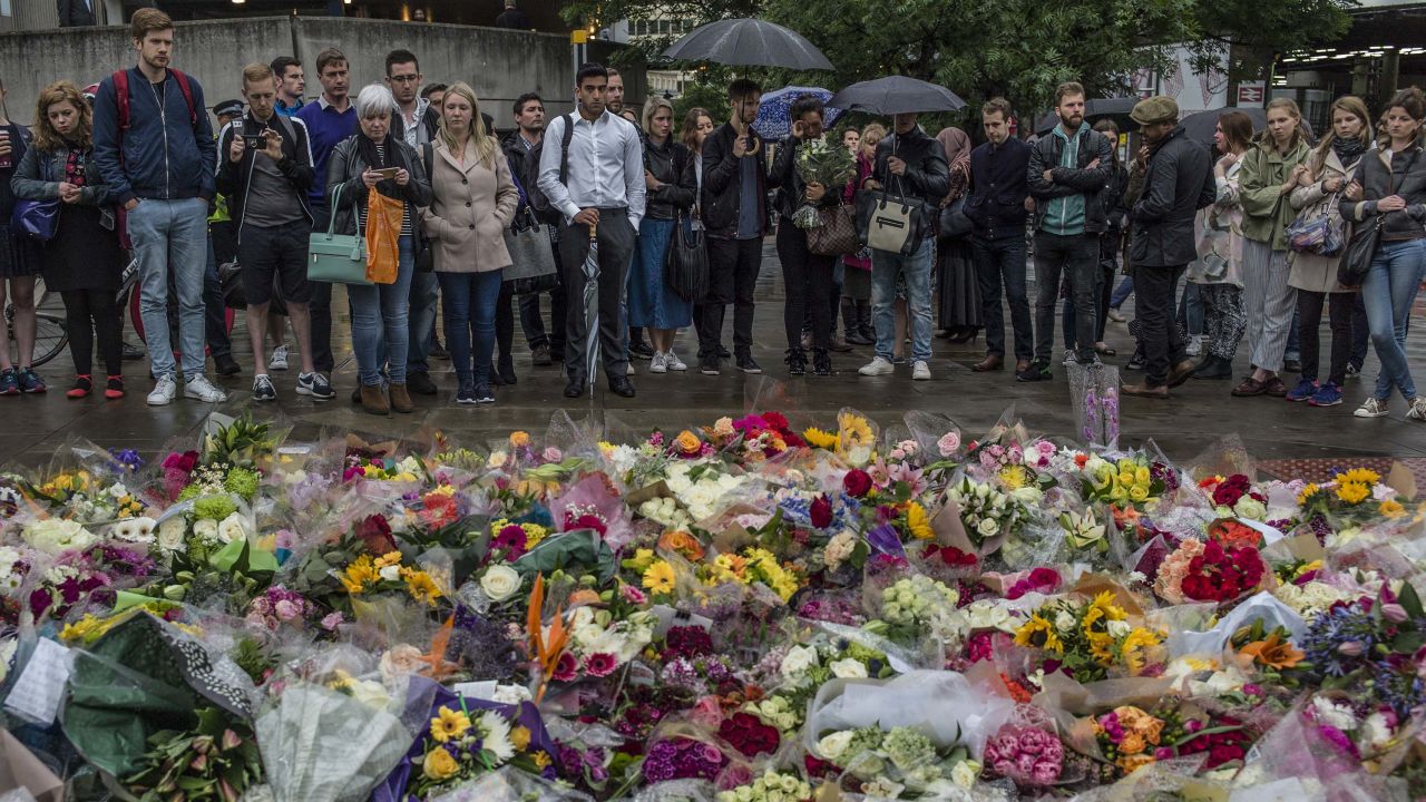 LONDON, ENGLAND - JUNE 05:  Members of the public gather near flowers on the South side of London Bridge, close to Borough Market in London in tribute to the victims of the June 3 attacks, on June 5, 2017 in London, England. British police on Monday made several arrests in two dawn raids following the June 3 London attacks, claimed by the Islamic State group which left seven people dead.  (Photo by Dan Kitwood/Getty Images)