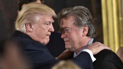 US President Donald Trump (L) congratulates Senior Counselor to the President Stephen Bannon during the swearing-in of senior staff in the East Room of the White House on January 22, 2017 in Washington, DC. / AFP / MANDEL NGAN (Photo credit should read MANDEL NGAN/AFP/Getty Images)