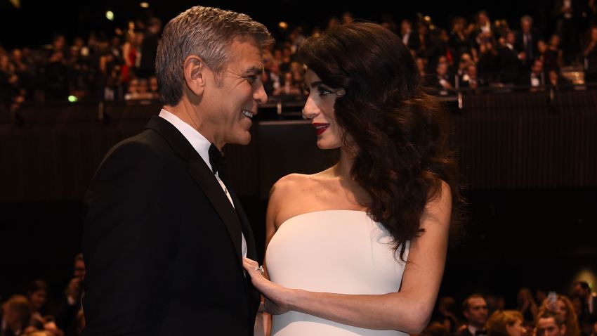 US actor George Clooney (L) and his wife British-Lebanese lawyer Amal Clooney pose as they arrive for the 42nd edition of the Cesar Ceremony at the Salle Pleyel in Paris on February 24, 2017. / AFP / bertrand GUAY        (Photo credit should read BERTRAND GUAY/AFP/Getty Images)