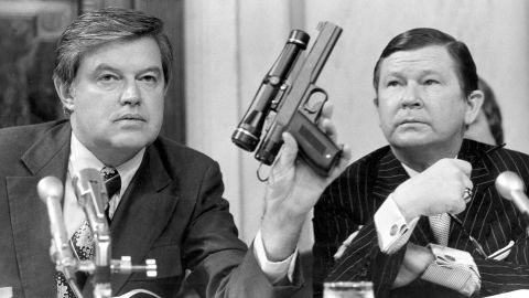 Committee Chairman Frank Church displays a poison dart gun during testimony about the CIA.