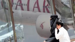 A picture taken on June 5, 2017 shows a Saudi woman and a boy walking past the Qatar Airways branch in the Saudi capital Riyadh, after it had suspended all flights to Saudi Arabia following a severing of relations between major gulf states and gas-rich Qatar.
Arab nations including Saudi Arabia and Egypt cut ties with Qatar accusing it of supporting extremism, in the biggest diplomatic crisis to hit the region in years. / AFP PHOTO / FAYEZ NURELDINE        (Photo credit should read FAYEZ NURELDINE/AFP/Getty Images)