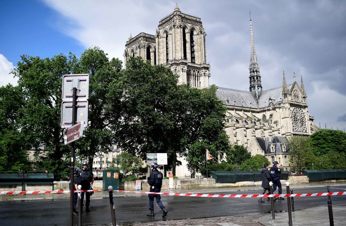 French police gather Tuesday at a cordoned-off area at Notre-Dame Cathedral in Paris.