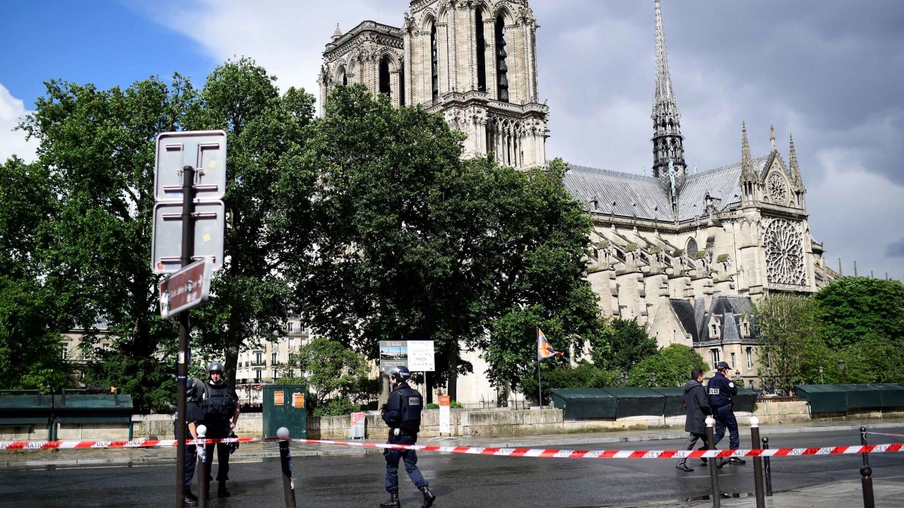 French police gather Tuesday at a cordoned-off area at Notre-Dame Cathedral in Paris.