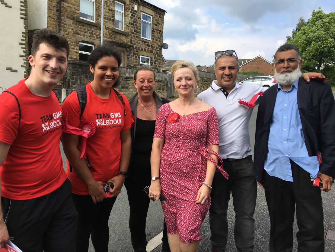 Tracy Brabin (center, in red dress) with part of her team on the campaign trail. After less than a year as an MP in Westminster, Brabin is fighting for re-election.