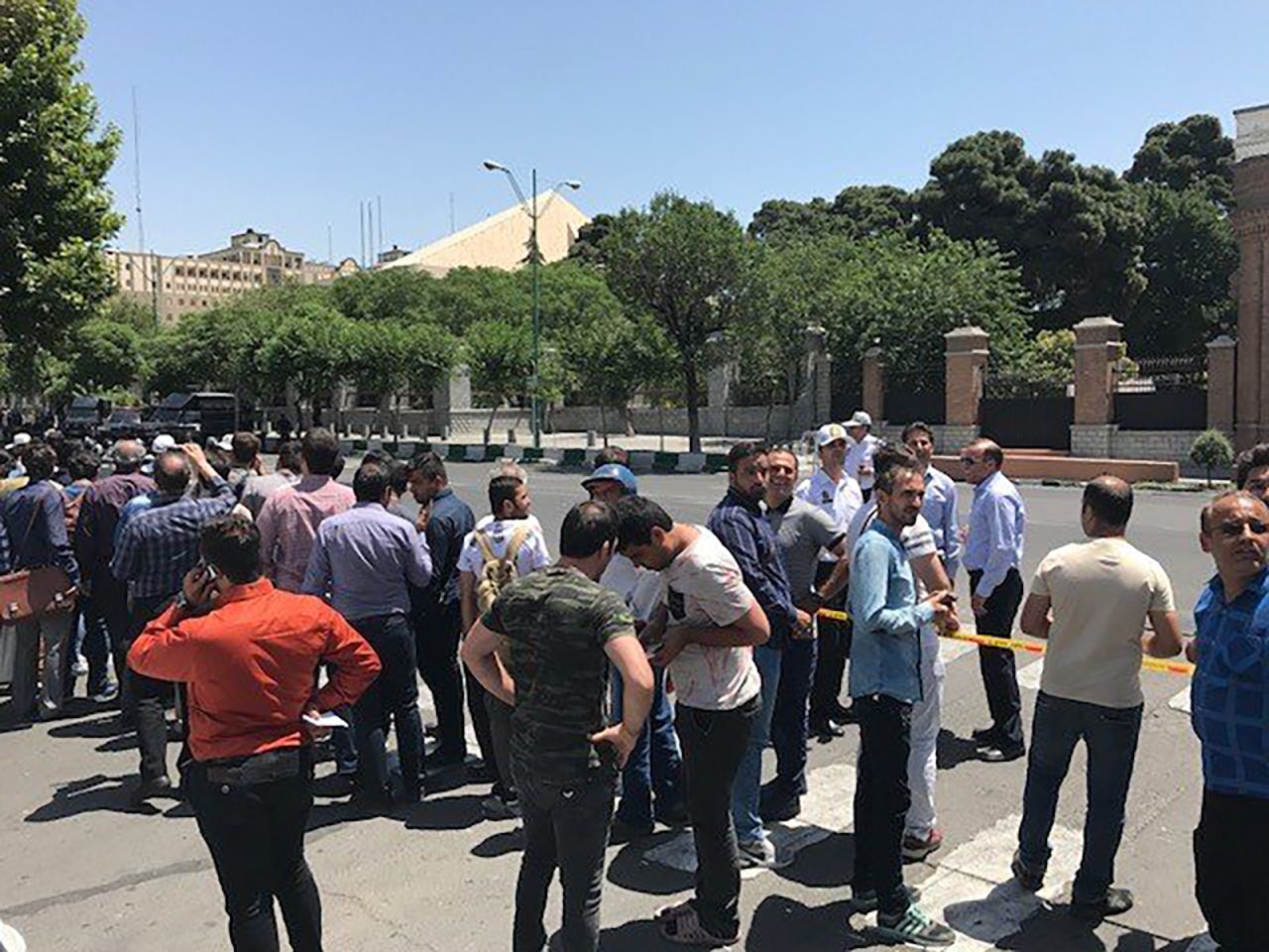 People gather Wednesday outside the parliament building in Tehran.