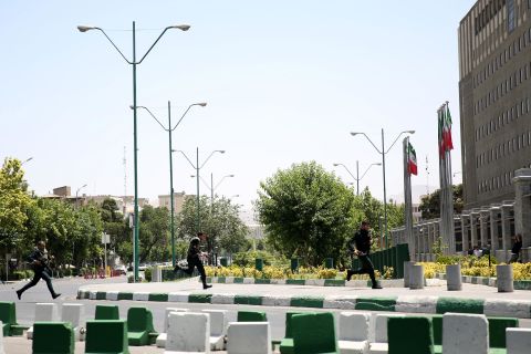 Police on Wednesday storm the parliament building in Tehran.