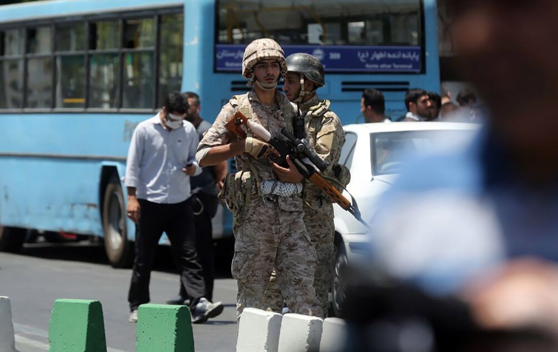 Iranian soldiers stand guard near parliament during the attack Wednesday.
