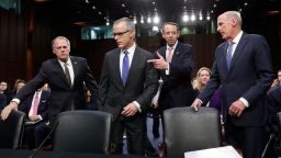 Jim Wolfe, committee staff member, left, helps direct acting FBI Director Andrew McCabe, second left, Deputy Attorney General Rod Rosenstein, and National Intelligence Director Dan Coats to their seats for a Senate Intelligence Committee hearing about the Foreign Intelligence Surveillance Act, on Capitol Hill, Wednesday, June 7, 2017, in Washington. (AP Photo/Alex Brandon)