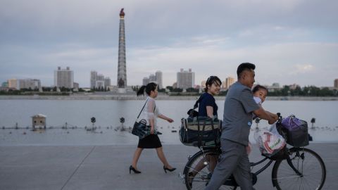 North Koreans walk past the Juche Tower in Pyongyang. The country has criticized Trump's decision to withdraw from the Paris climate agreement.