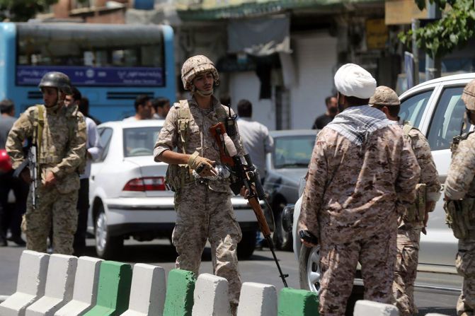 Members of Iran's Revolutionary Guard secure the area outside the parliament complex in Tehran during an attack Wednesday.