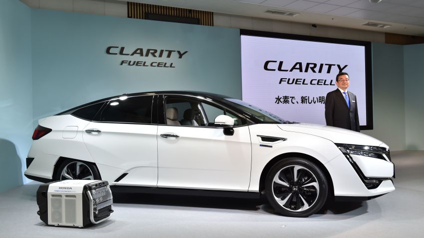 Honda Motors President Takahiro Hachigo poses with its new fuel cell vehicle (FCV), the Clarity Fuel Cell during a press preview at the company's headquarters in Tokyo on March 10, 2016. 
Honda Motor announced on March 10 that they will began sales in Japan of its all-new Clarity Fuel Cell. / AFP / KAZUHIRO NOGI        (Photo credit should read KAZUHIRO NOGI/AFP/Getty Images)