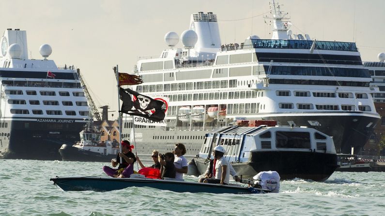 <strong>Protest against cruise ships: </strong>Locals believe that cruise shops and their passengers are ruining the canals and the city. This picture was taken during a protest in September 2013. Protesters use a boat to block cruise ships sailing through the Giudecca Canal. 