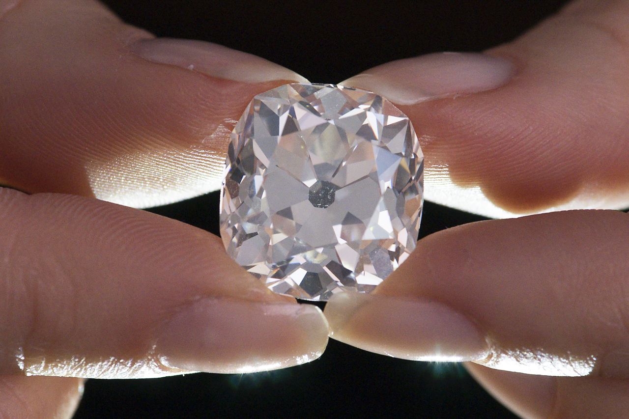 A member of Sotheby's staff holds the diamond at Sotheby's auction house in London.