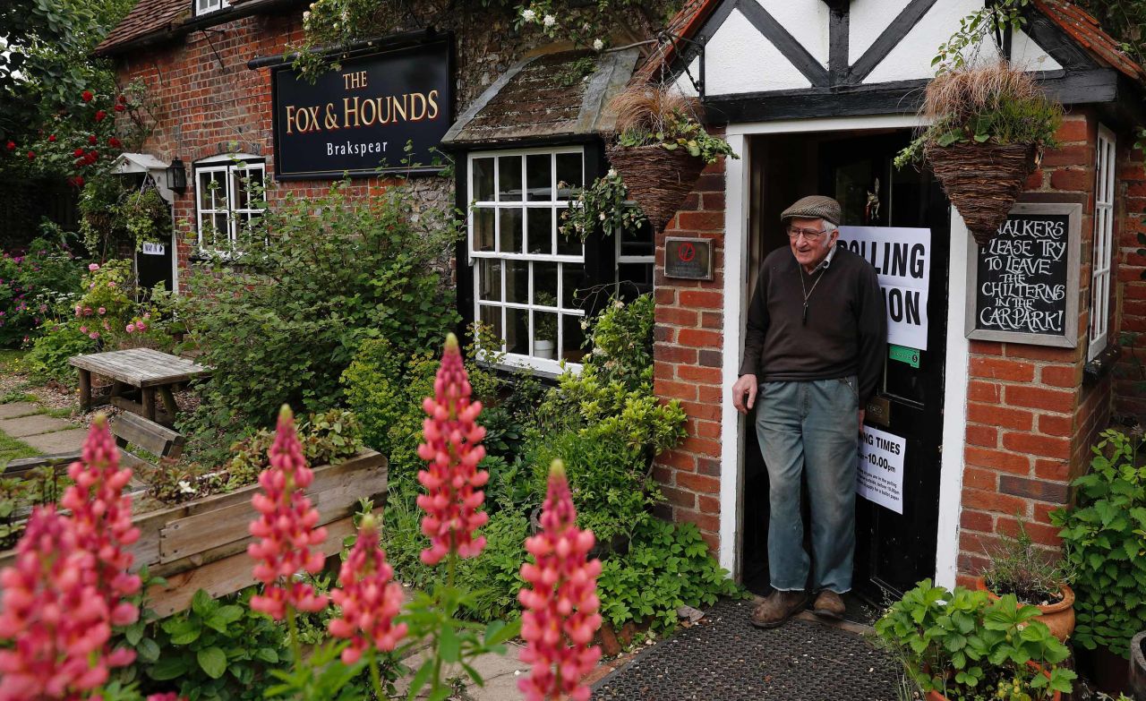 A man leaves a polling station at a pub in Christmas Common, near Oxford, England.
