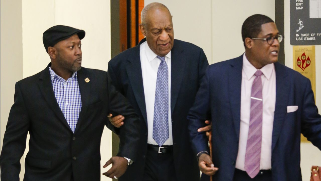Actor Bill Cosby and aide Andrew Wyatt arrive in 2017 for Cosby's trial on sexual assault charges in Pennsylvania.