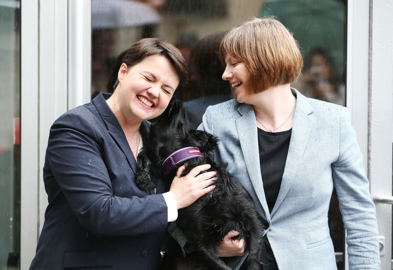 Scottish Conservative leader Ruth Davidson, left, arrives with her partner, Jen Wilson, to cast her vote in Edinburgh, Scotland.