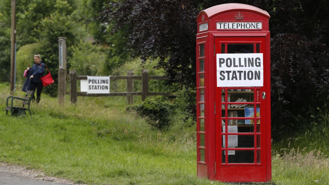 A sign is seen on a telephone box outside a polling station at Rotherwick Hall, west of London.