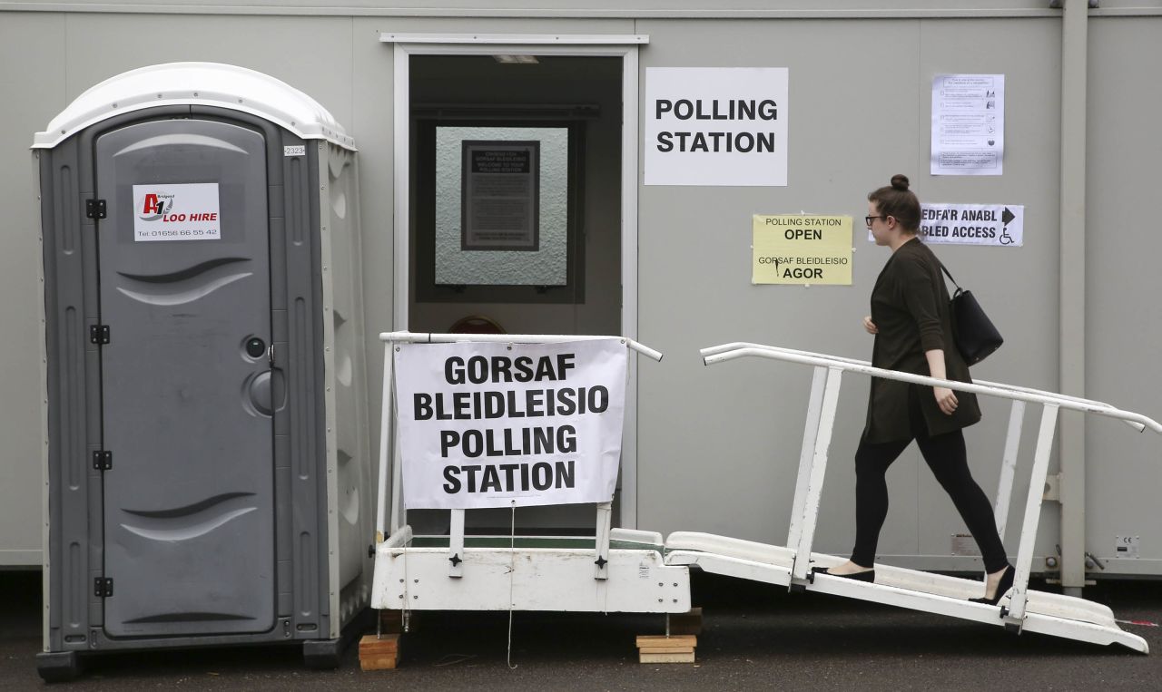 A woman walks into a polling station in Cardiff.