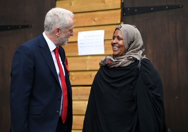 Labour Party leader Jeremy Corbyn speaks to a member of the public before casting his vote at a school in London.